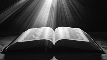 An open bible with rays of light shining through it photo