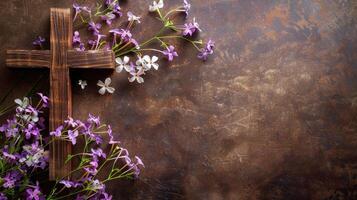 Easter cross on a rustic background with purple flowers photo