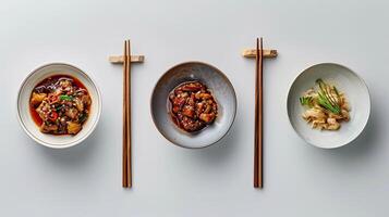 Three plates with food on them and chopsticks photo