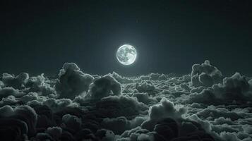 A full moon is seen over the clouds photo