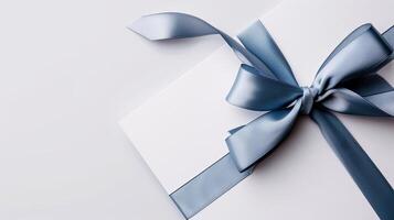 A white gift box with a blue ribbon photo