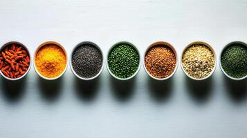 Healthy Superfoods Goji Berries Turmeric Chia Seeds Mung Beans Flax Seeds Hemp Seeds in Bowls photo