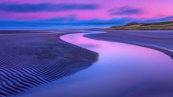 Serene Coastal Landscape at Sunset Pink and Purple Sky Reflecting on a Beach Creek with Sand Ripples photo