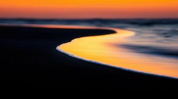 Golden Sunset Waves Gently Kissing Dark Sand Beach at Dusk Ocean Seascape photo