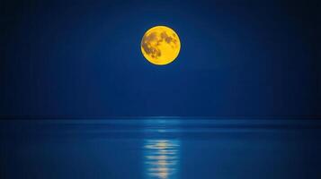 Serene Night Scene A Large Yellow Moon Reflecting on Calm Ocean Waters Perfect for tranquility and nature themes photo
