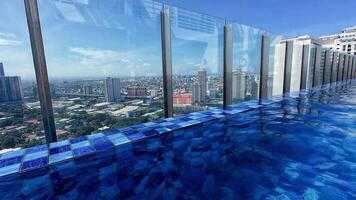 Stunning rooftop pool views of the Manila skyline under a clear sky. video