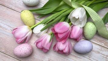 Tulips and easter eggs create a spring feeling on a wooden table video