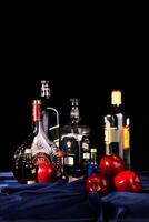 A table with a bottle of liquor, a bottle of wine, and a bottle of beer photo