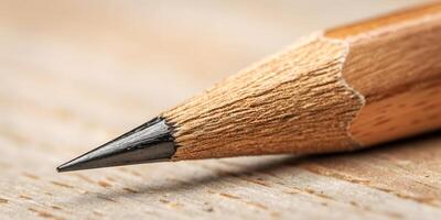Close-Up of Wooden Pencil Tip with Graphite Point and Textured Wood Grain on Beige Background photo