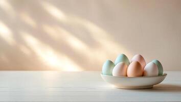 Wooden light table with eggs and blurred sunny background on light wall. Soft warm tones. Minimalistic composition on Happy Easter theme. Place for insertion. . photo