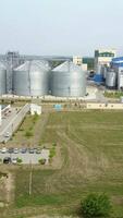 Row of granaries for storing wheat and other cereal grains. Aerial view Vertical video