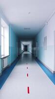 Modern hallway in educational center. Long corridor in blue color with doors and large windows in the university. Vertical video