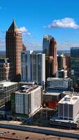 Modern dynamic Atlanta downtown at daytime. Busy traffic in the city by the wide highways. Top view. Vertical video