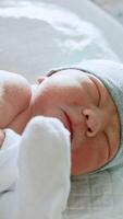 Neonatologist is listening to a baby heart. The kid is unhappy about the check up. Close up. Vertical video