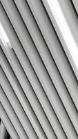 Black and white image of led lamps working on the embossed ceiling. Low angle perspective. Vertical video