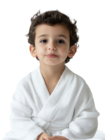 A young boy in a white robe sitting on a black background png