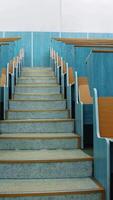 Empty auditorium. Stairs between two rows of desks in conference hall. Beautiful class for studying without students. Classroom in the university with wooden desks. Vertical video