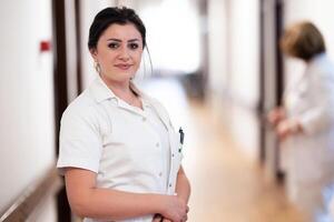 A dedicated nurse in uniform walks briskly down a well-lit hospital corridor, reflecting professionalism and urgency in a healthcare setting. photo
