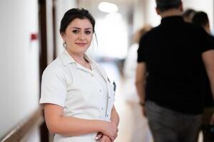 A tired nurse takes a quiet moment to rest in the hospital hallway, reflecting on a long and demanding shift. photo