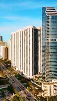 Diverse buildings in the architecture of Miami Beach. Sunny view of American city on the coast of the Atlantic Ocean. Vertical video
