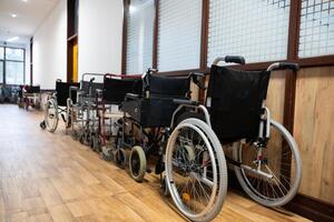A row of wheelchairs neatly lined up in a hospital corridor, ready for patients in need of mobility assistance photo