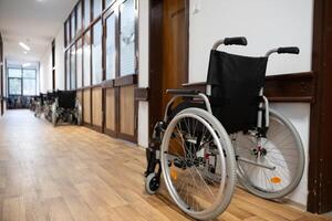 A row of wheelchairs neatly lined up in a hospital corridor, ready for patients in need of mobility assistance photo