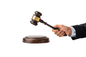 A polished wooden gavel with a golden band, grasped by a hand in formal attire, poised over a base, representing law and order png
