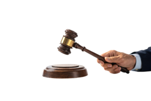 A judge's hand raises a gavel over a wooden base, symbolizing authority, judgment, and the process of delivering justice in the courtroom png