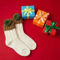 christmas socks with green pom poms on red background photo