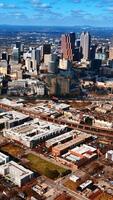 Breath-taking view of Atlanta panorama from aerial perspective. Light blue sky with many white clouds above. Top view. Vertical video