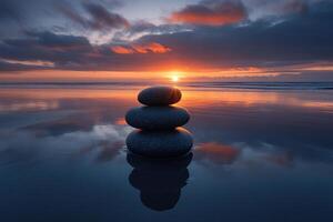 Three smooth stones are stacked in a pyramid on a sandbank on the seashore overlooking a stunning sunset. Generated by artificial intelligence photo