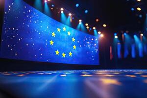 Yellow stars are arranged in a circle on a blue background of a screen installed on an empty stage. European Union, summit, meeting, event. Generated by artificial intelligence photo