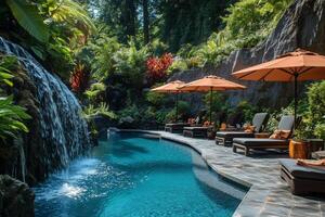 Resort Pool With Waterfall and Sun Loungers Surrounded by Tropical Plants in a Sunny Location photo