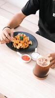 A man eating a plate of food photo