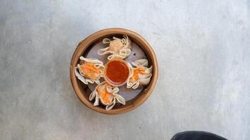 a wooden bowl with food on it photo