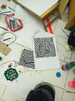 a table with various items on it, including a drawing photo
