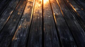 A perspective view of black wooden planks illuminated by warm golden light, creating a dramatic and elegant atmosphere photo