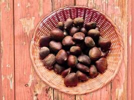 A basket full of chestnuts on a wooden table video