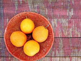 Three oranges are in a basket on a wooden table video