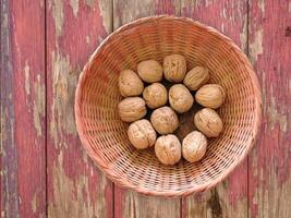 Walnuts in a basket on a wooden background video