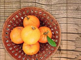A basket of oranges on a wooden table outdoor video