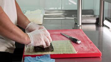 Preparing fresh ingredients at a kitchen counter in a bustling restaurant video