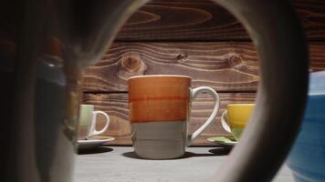 Warm beverages served in artistic mugs on a rustic wooden table in a cozy cafe during an afternoon gathering with friends video
