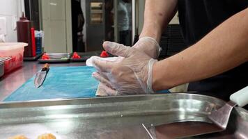 Mastering sushi preparation techniques in a professional kitchen during a culinary workshop video