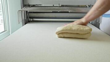 Dough preparation and rolling process in a bakery during daytime video