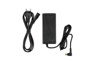 A black power adapter with two cables, one ending in a plug for an outlet and the other in a connector for a device, isolated on a white background. photo