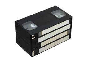 Four retro tapes stacked together, featuring blank labels and black casings, a timeless piece of analog history. photo