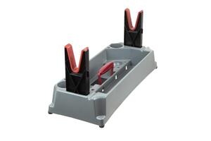 A versatile gun cleaning tool with a gray plastic base, integrated compartments, red and black V-shaped holders, and a functional red handle. photo