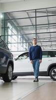 Man Browsing Cars at a Modern Dealership Showroom video