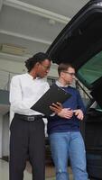 Car Salesman Showing Trunk Space to Potential Buyer video